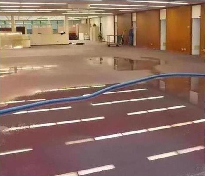 water on the floor of a large office space