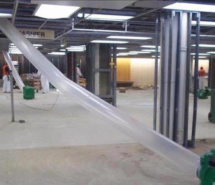 the inside of an empty store with drying equipment set up 